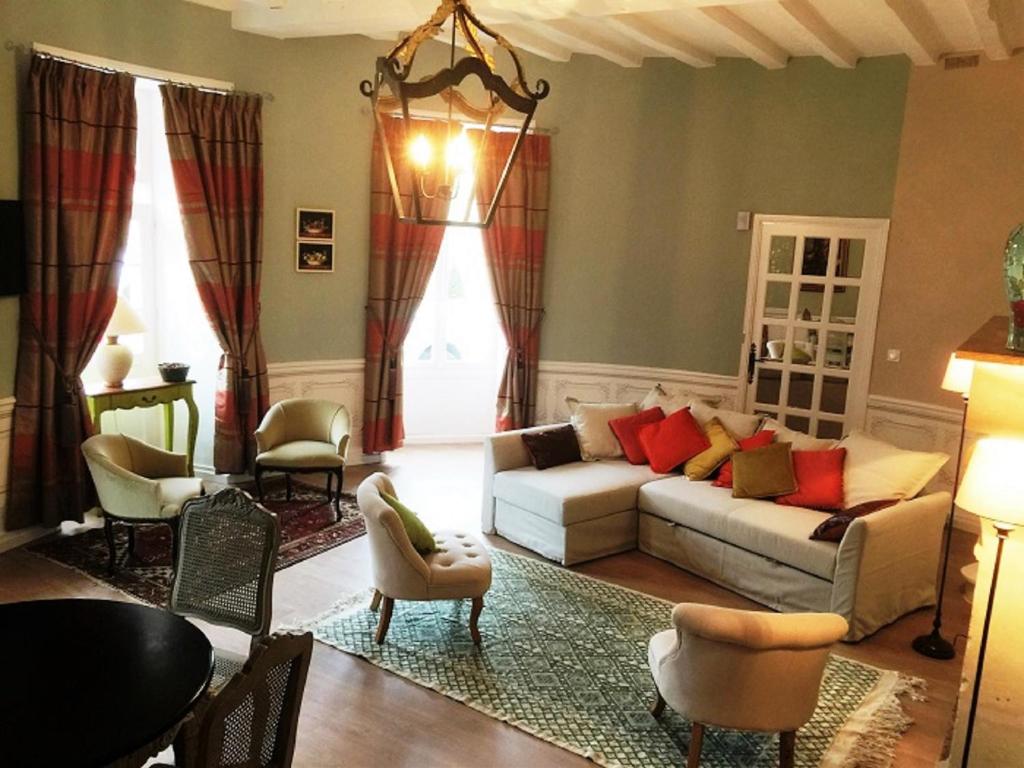 a living room with a couch and chairs at Cottage de la Tour - Duplex troglodyte of 100 m in Azay-le-Rideau