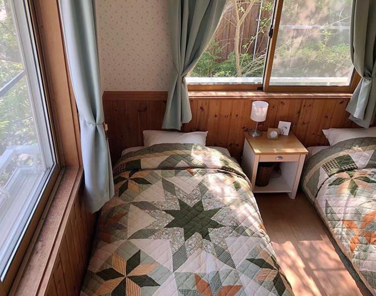 Postel nebo postele na pokoji v ubytování Guest House Chaconne Karuizawa