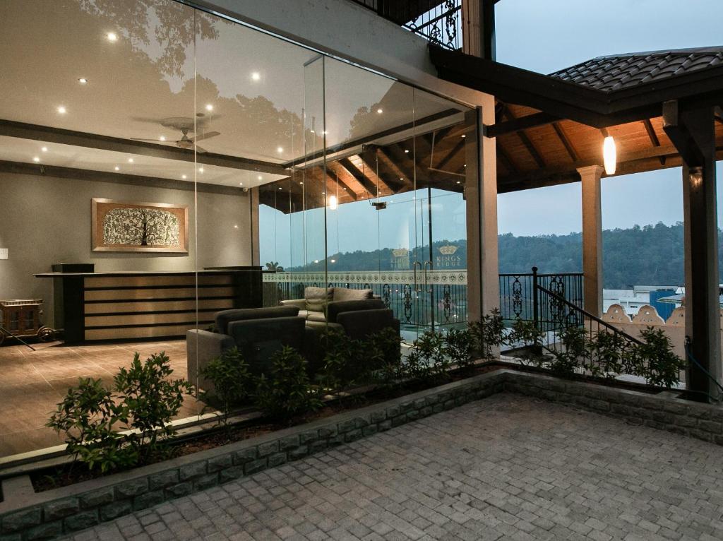 a living room with a couch and a large window at Kings Ridge Kandy in Kandy