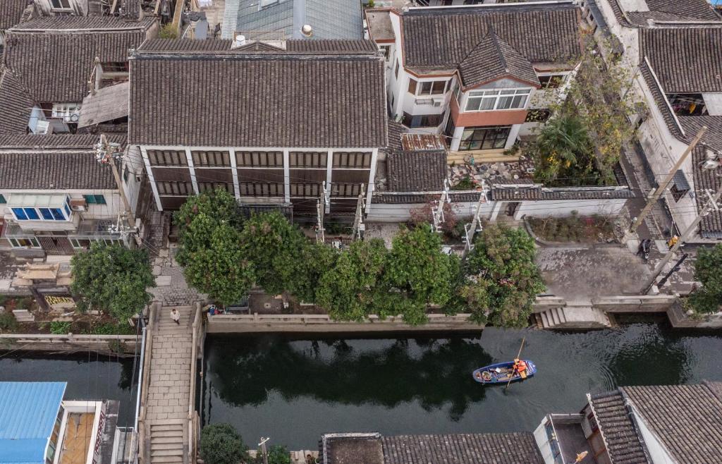 a boat in a river in a city at Suzhou Jade Snow Lodge in Suzhou