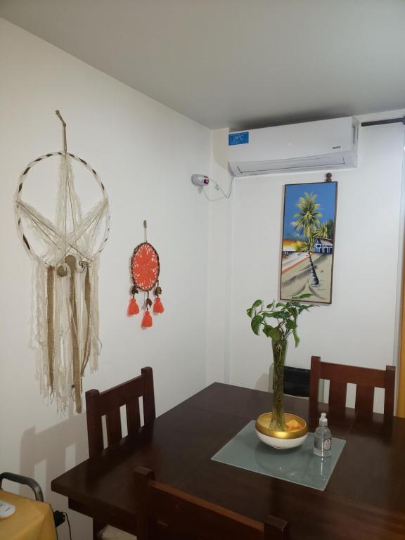 a dining room with a table with a plant on it at Colón in Cordoba