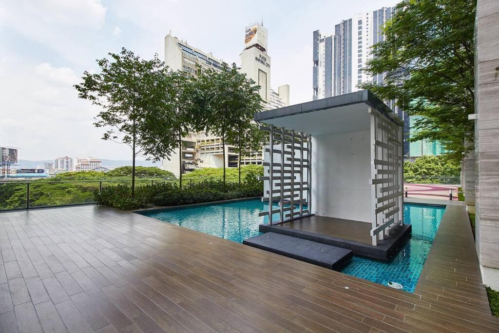 a building with a swimming pool in a city at 2BR Apartment at Jalan Ampang, minutes to KLCC in Kuala Lumpur