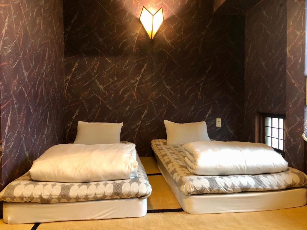 Postel nebo postele na pokoji v ubytování Hostel Yume-Nomad Kobe
