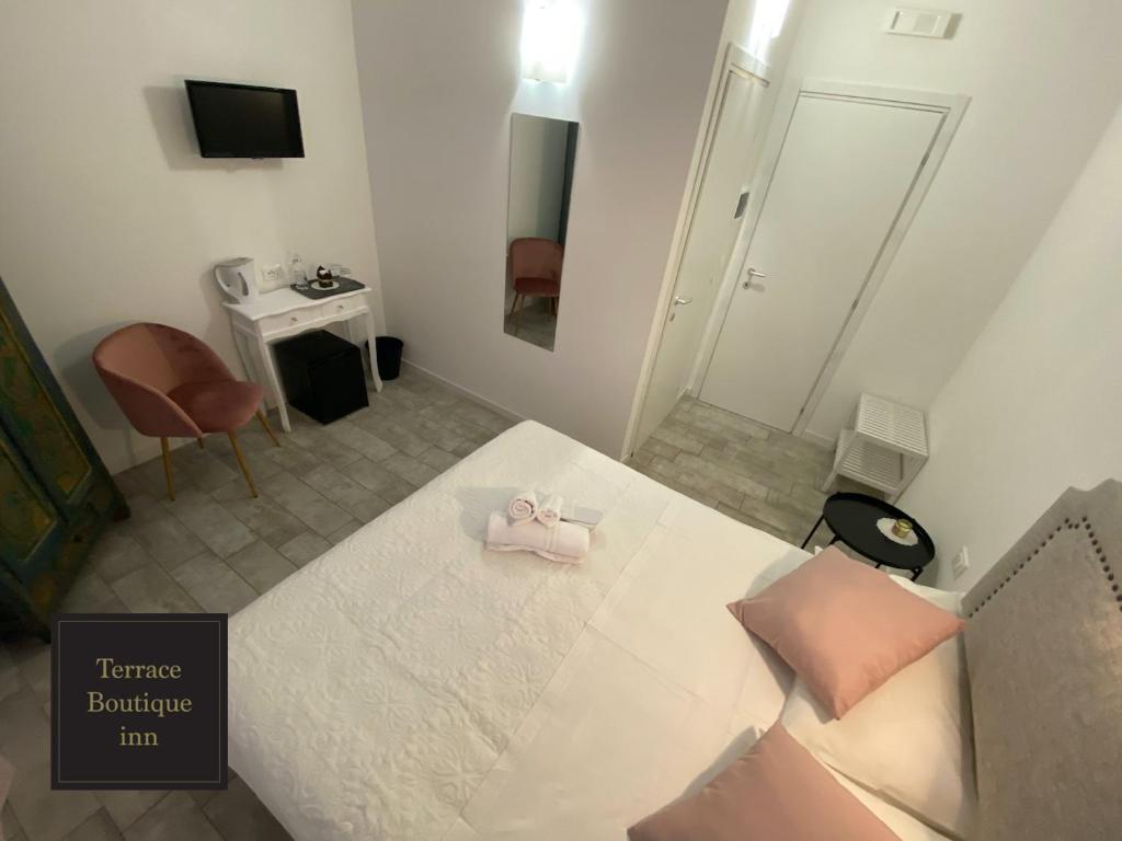 A bed or beds in a room at Terrace Boutique Inn