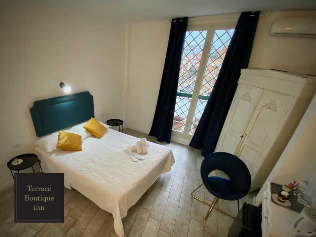 A bed or beds in a room at Terrace Boutique Inn