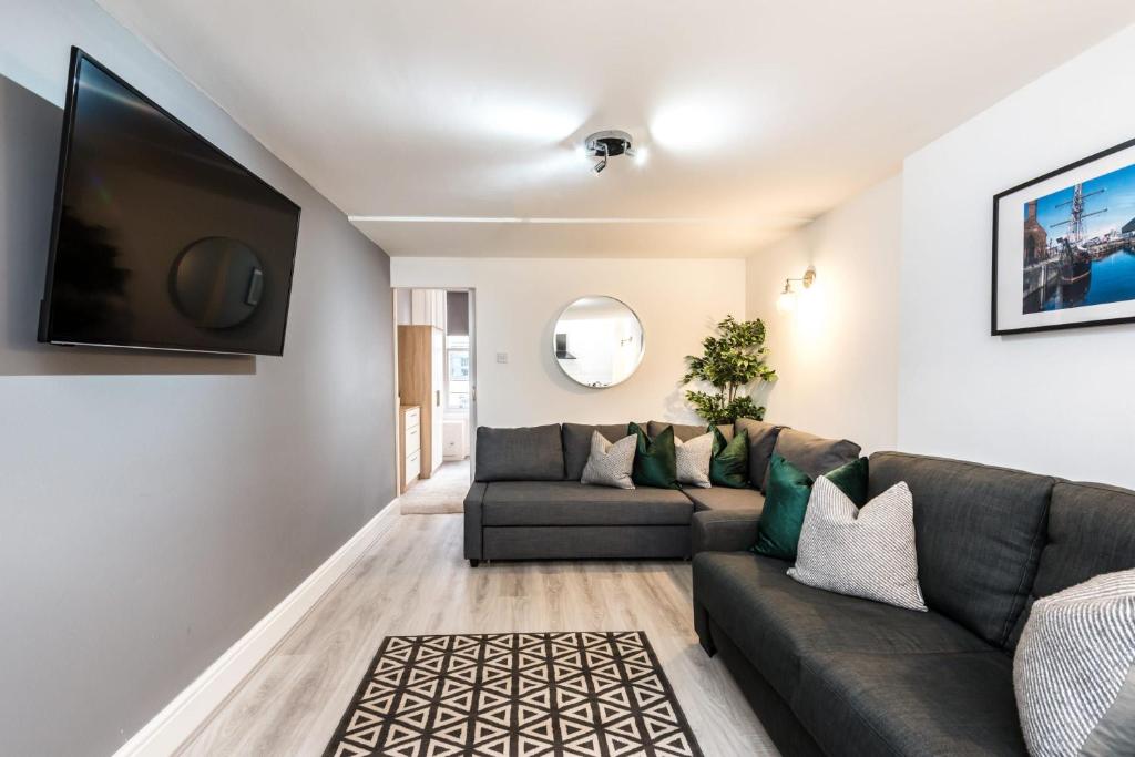 a living room with a couch and a flat screen tv at Host & Stay - Duke Street Townhouse Apartments in Liverpool