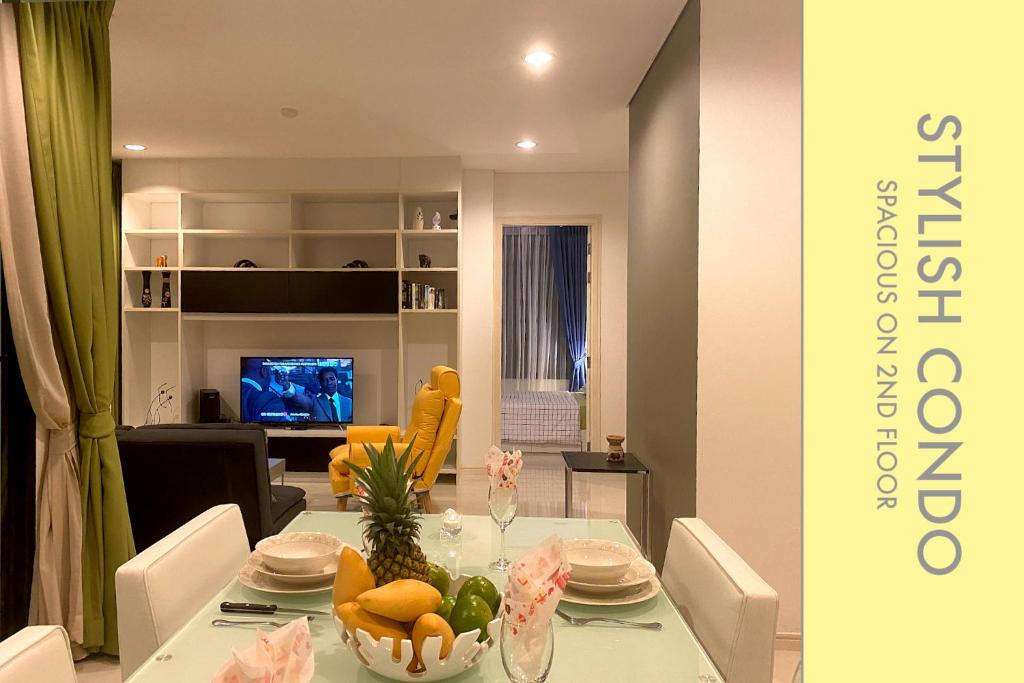 a dining room with a table with fruit on it at Stylish Condo w. Pool View 2F in Kamala Beach