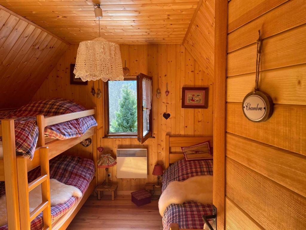 a bedroom with two bunk beds in a cabin at Chalet Le Cerf in Wildersbach