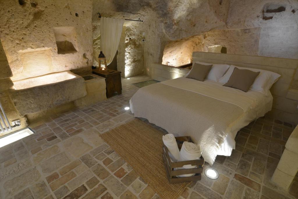 Posteľ alebo postele v izbe v ubytovaní Grotta Gea Luxury Home con Piscina & Spa