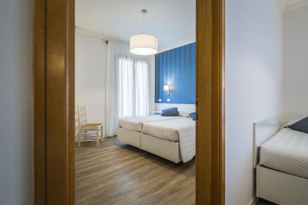 Postel nebo postele na pokoji v ubytování Hotel Capanna d'Oro