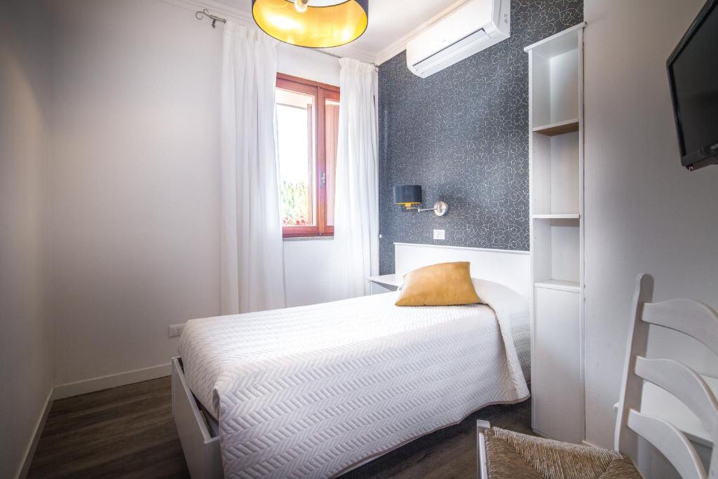 Postel nebo postele na pokoji v ubytování Hotel Capanna d'Oro