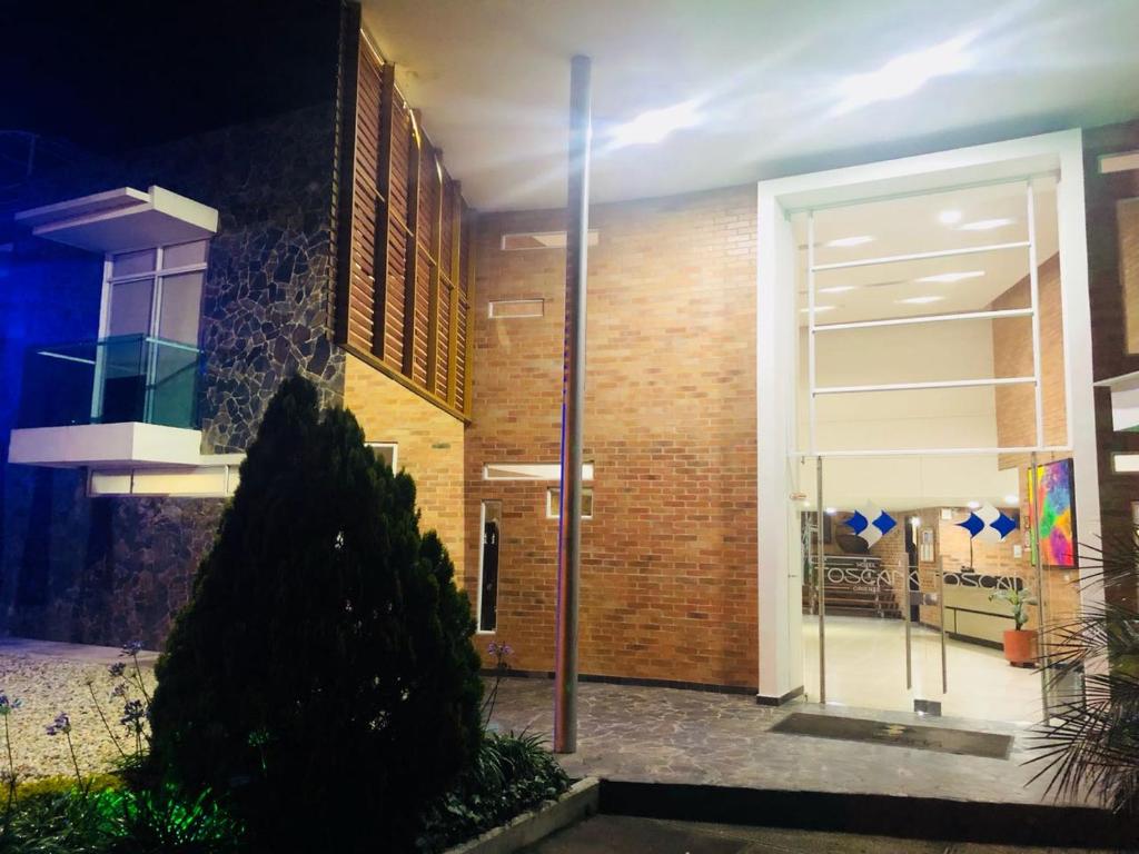 a front door of a building at night at Hotel Toscana Oriente in Rionegro