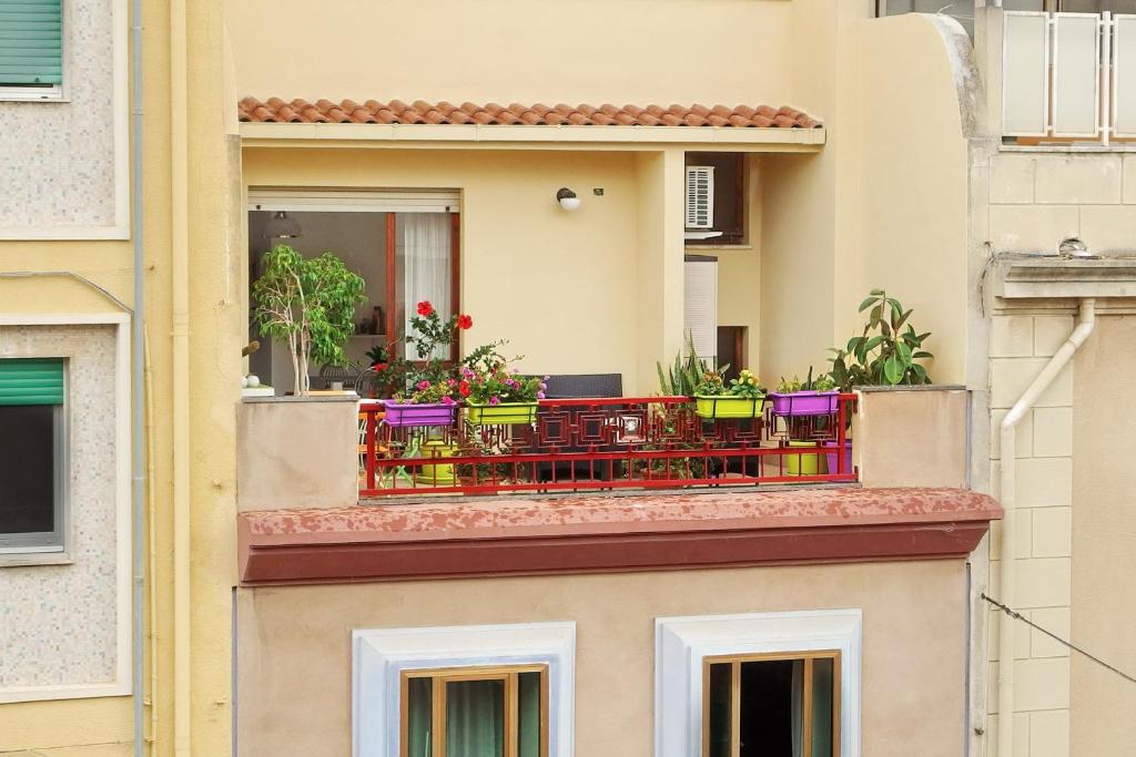 a balcony with flowers on a building at I Love Art in Cagliari