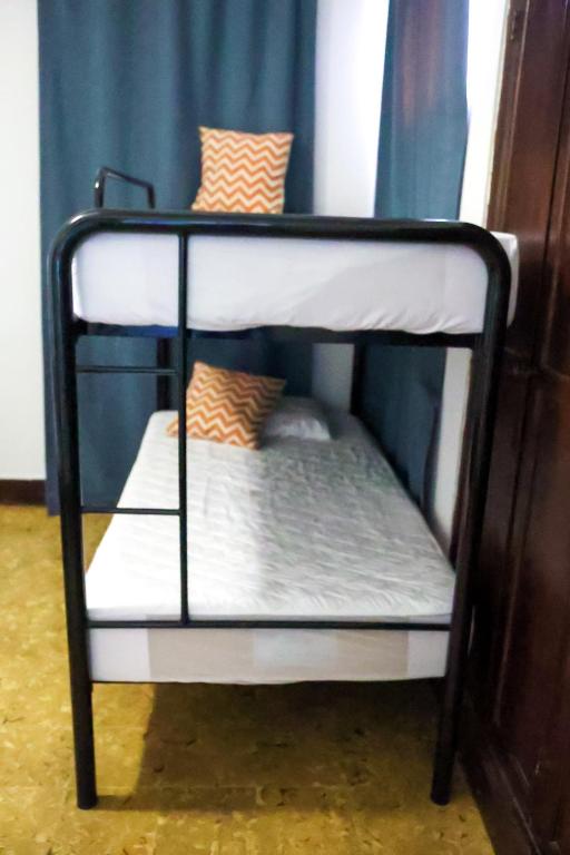 Postel nebo postele na pokoji v ubytování Hostal Villa Grande