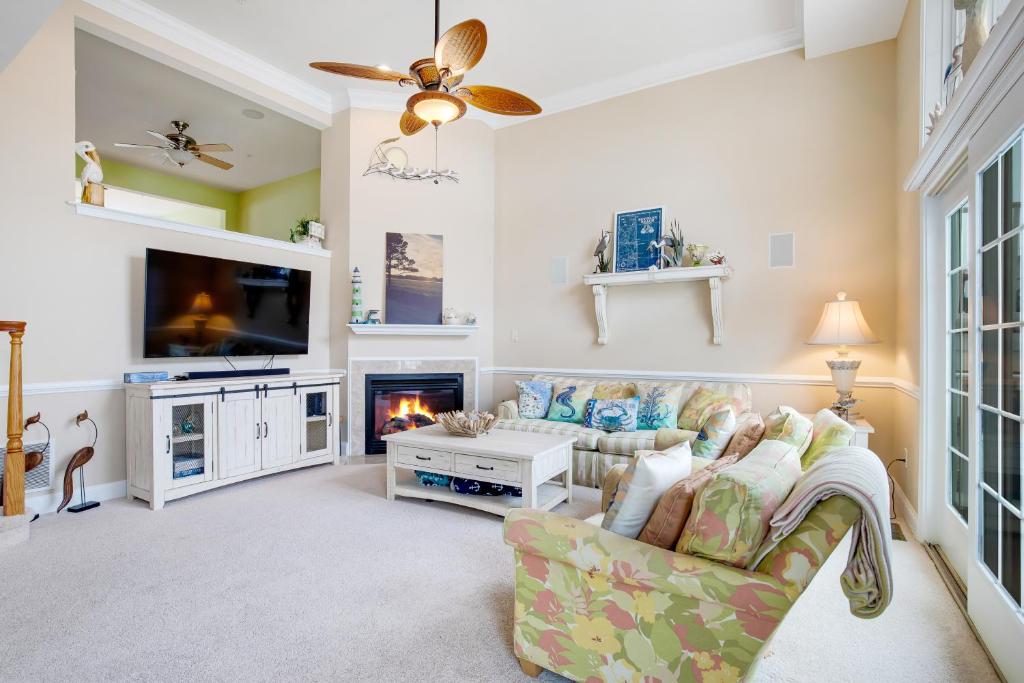 a living room with a couch and a fireplace at Bayside Bethany Lakes in Ocean View