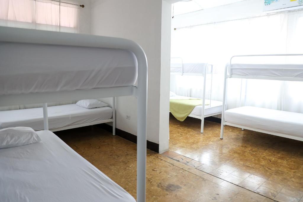 Postel nebo postele na pokoji v ubytování Hostal Villa Grande