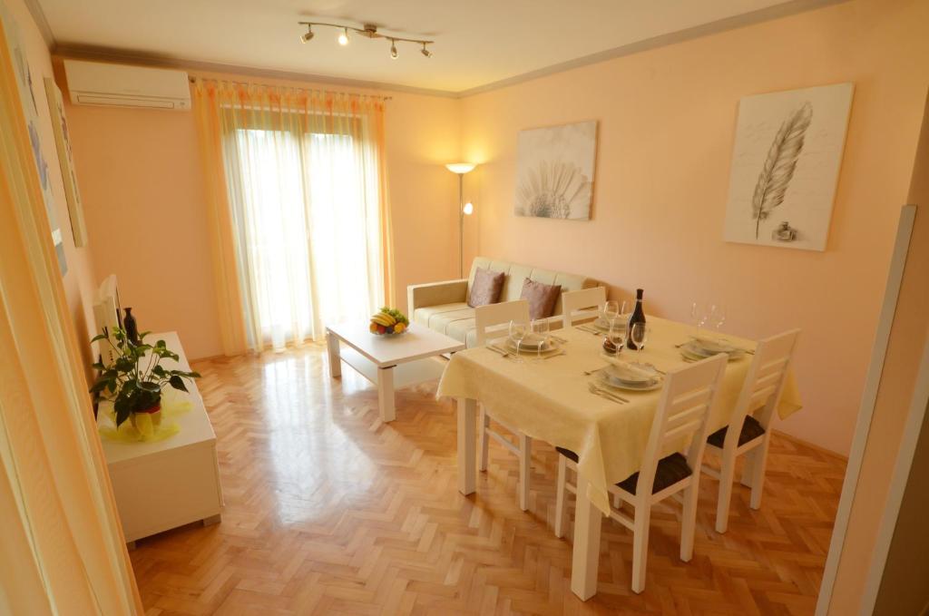 a living room with a table and a dining room at Bernardo Apartment in Rovinj