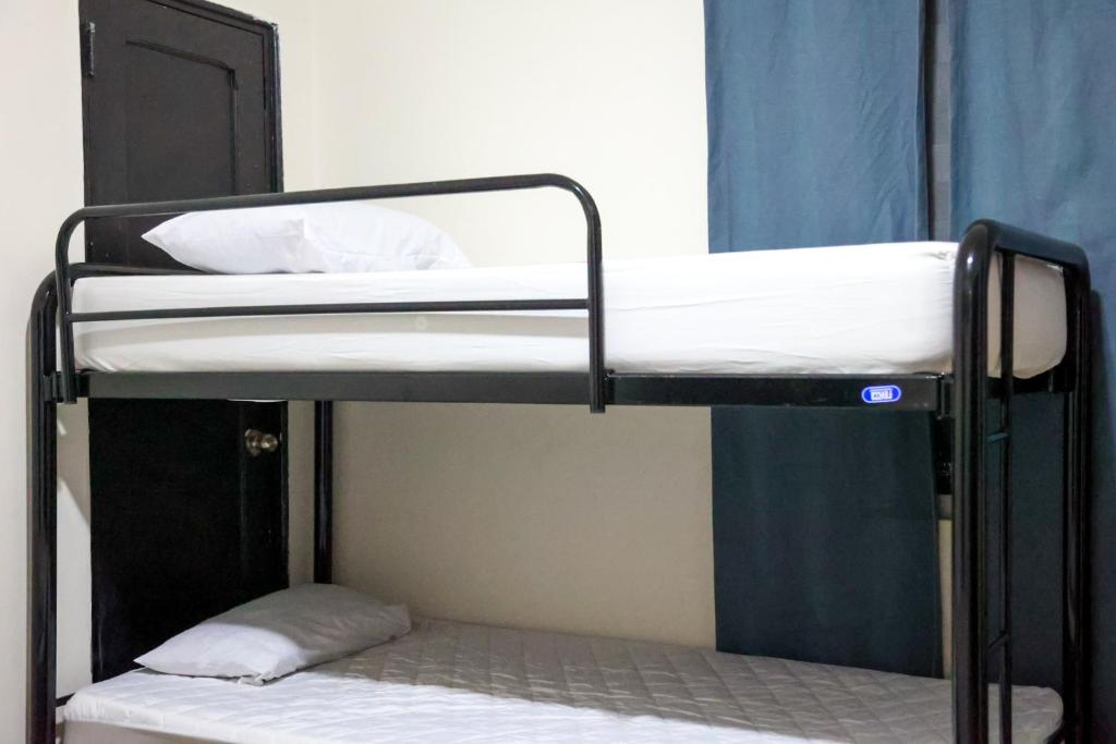Postel nebo postele na pokoji v ubytování Hostal Villa Grande