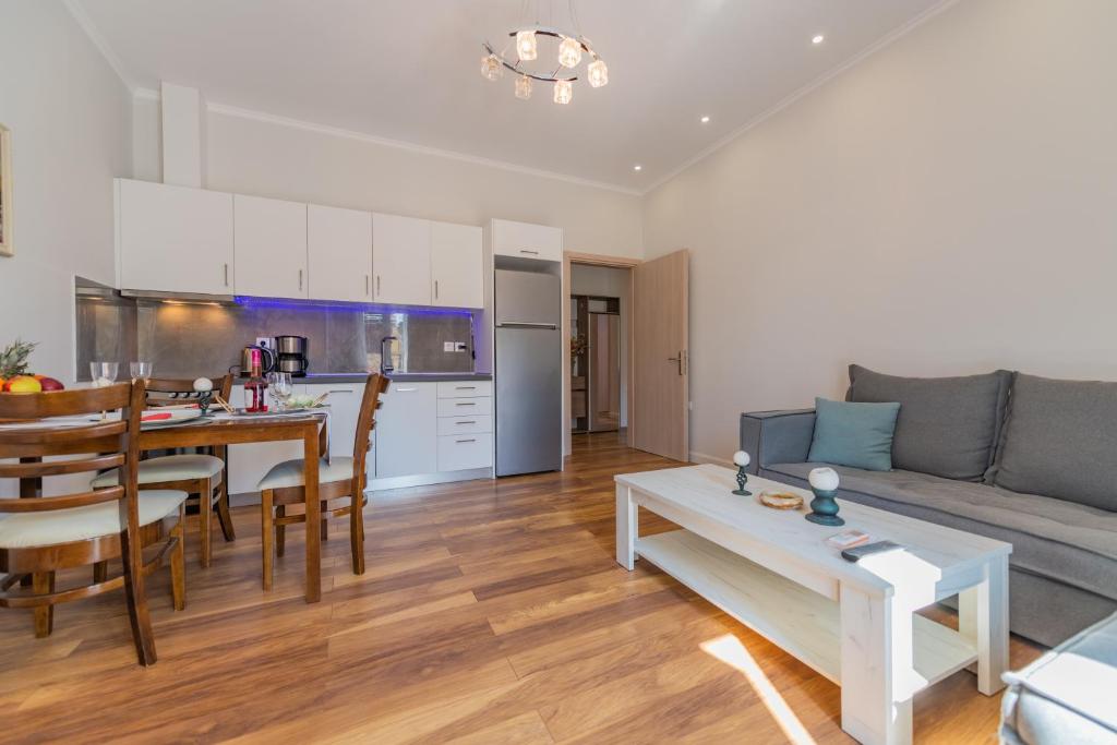 uma cozinha e uma sala de estar com um sofá e uma mesa em Jordi apartment em Corfu Town