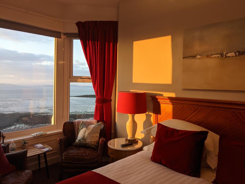 a hotel room with a bed and a large window at The Broadwater Guest House in Morecambe