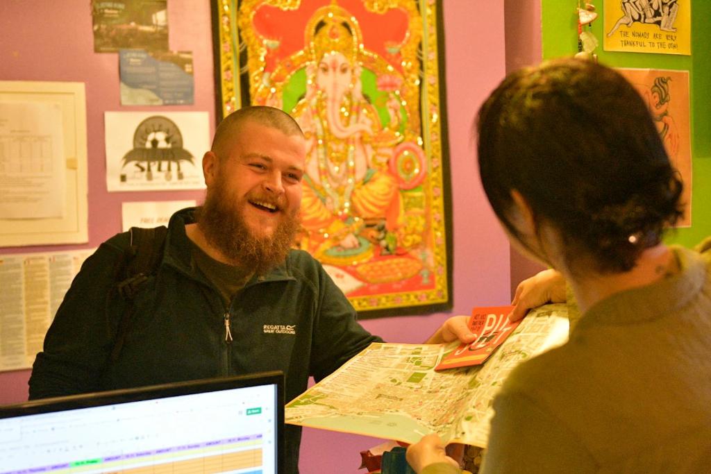 a man talking to a woman in a room at Outlanders Tribe Hostel in Split