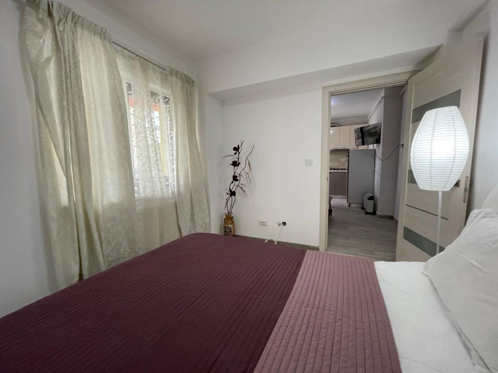 a bedroom with a large bed with a purple blanket at Renting Solutions Iulius Mall in Iaşi