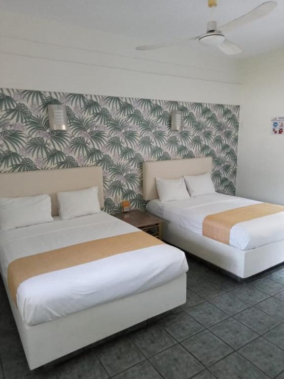 Postel nebo postele na pokoji v ubytování Hotel Gran Palmeiras