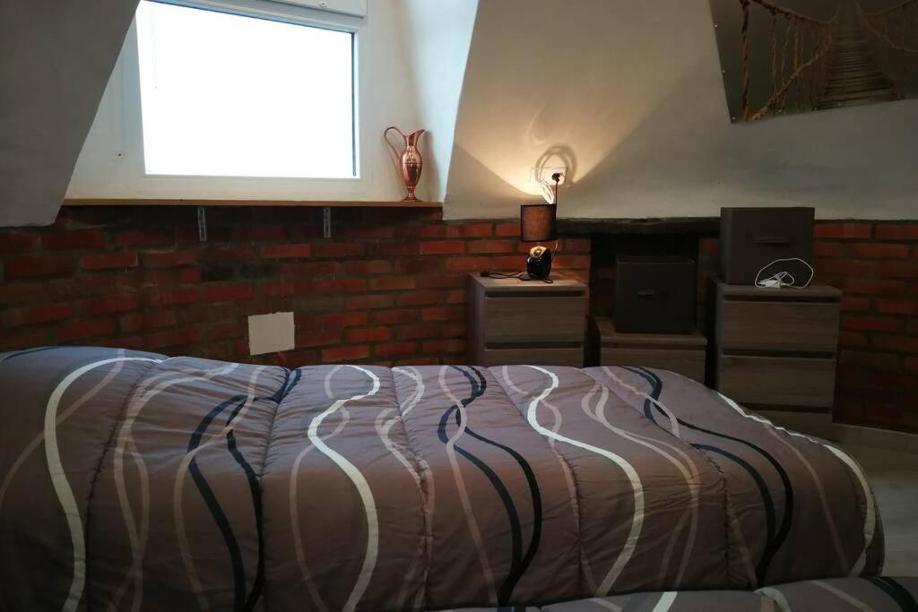 a bedroom with a bed and a window in it at Moulin de vairé in Vairé
