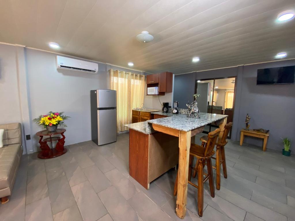 a kitchen with a table and chairs and a refrigerator at Harmonious House in Sierpe