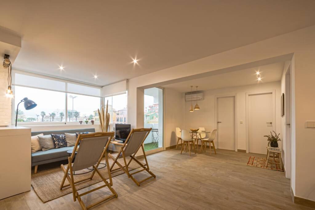 a living room with a couch and a table and chairs at K-SPACE by Nuka Homes in Jávea