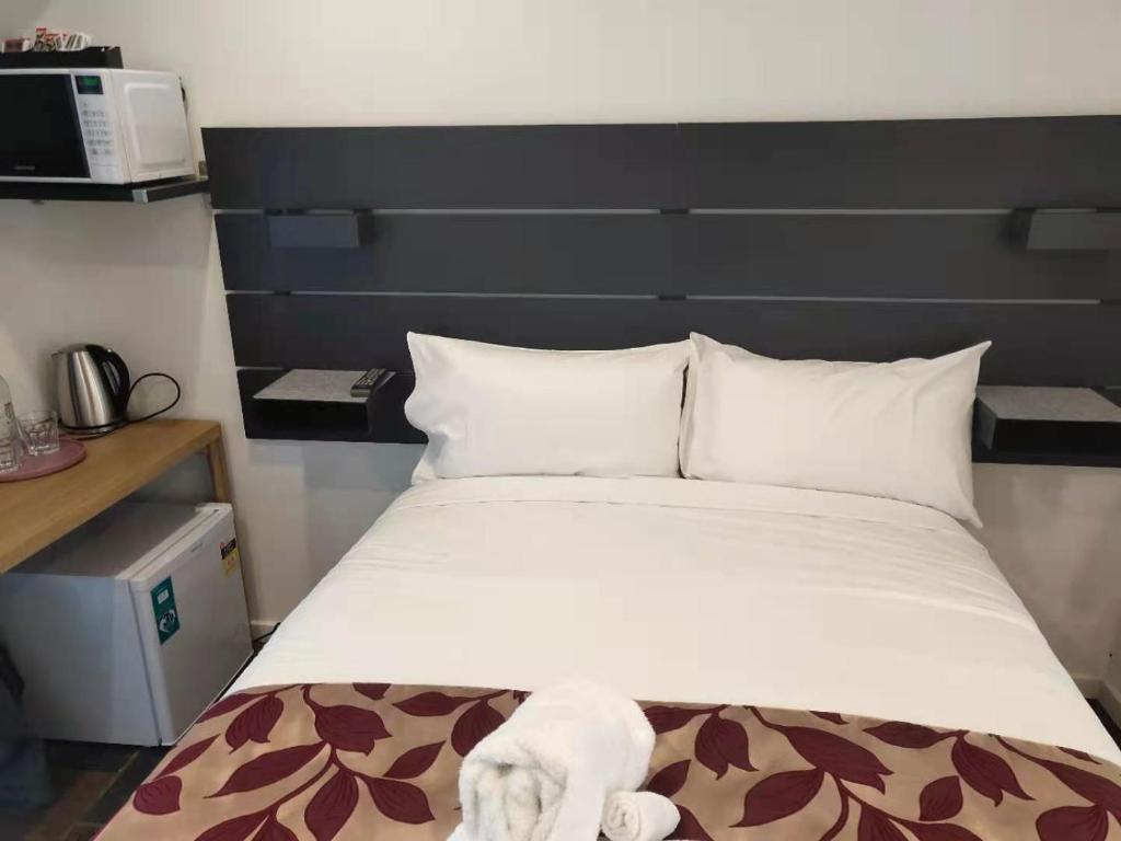 Postel nebo postele na pokoji v ubytování Coachman Motel and Holiday Units