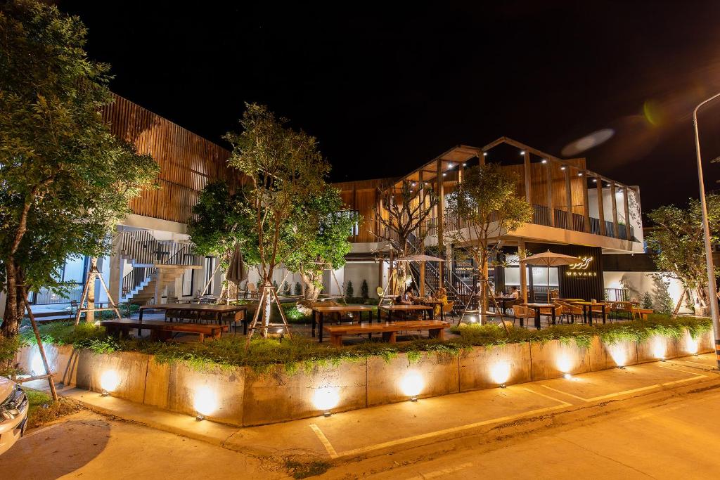 a building with tables and benches at night at Wevari Heritage in Nan