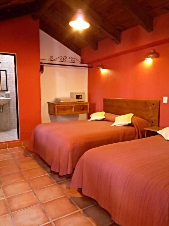 Postel nebo postele na pokoji v ubytování Hotel Casa Margarita