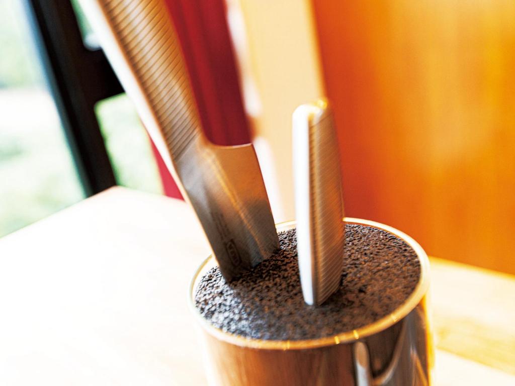 two toothbrushes sitting in a holder on a table at CHULAX OKINAWA YOMITAN【Designer Condominium Hotel】 in Yomitan