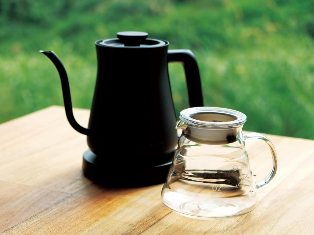 a black kettle and a glass jar on a table at CHULAX OKINAWA YOMITAN【Designer Condominium Hotel】 in Yomitan