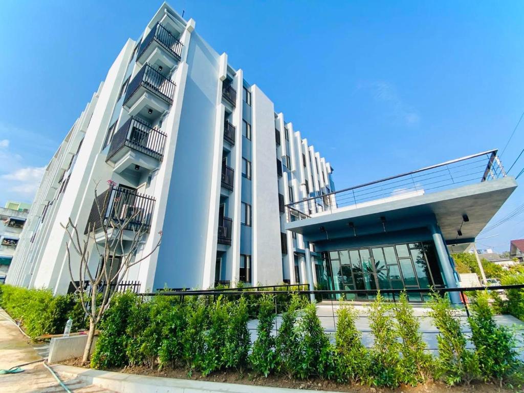 a large white building with balconies on it at ABIZZ Hotel KwanPhayao in Phayao