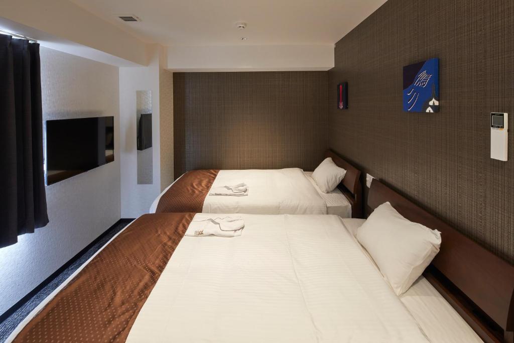 Postel nebo postele na pokoji v ubytování HOTEL BRILLER Kyoto Station South