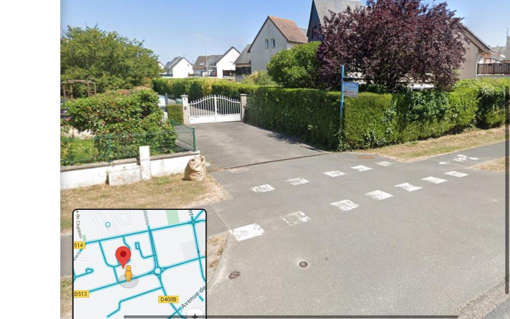 an empty street with a street sign on the road at La Cornaline 1 in Cabourg