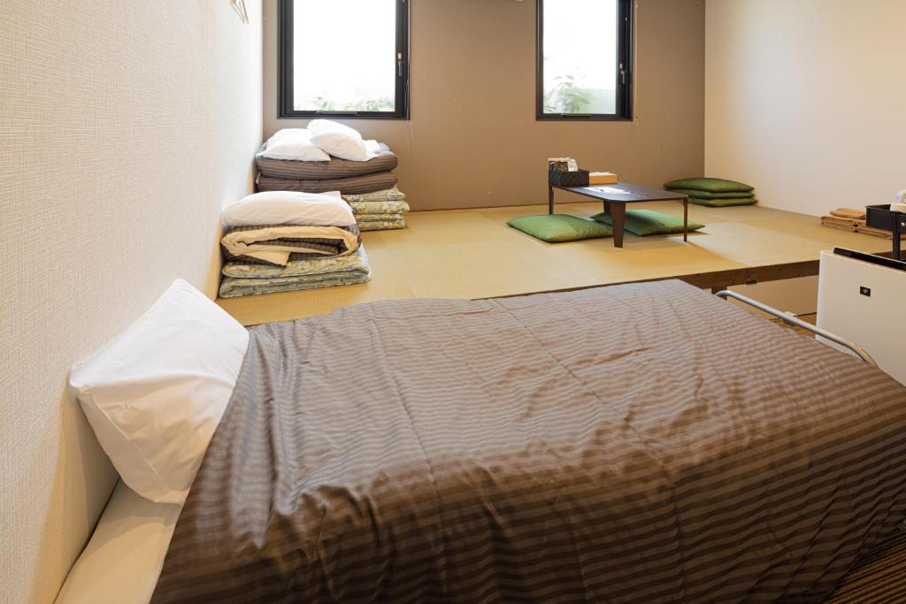 Postel nebo postele na pokoji v ubytování Hotel Tohko HakataGion
