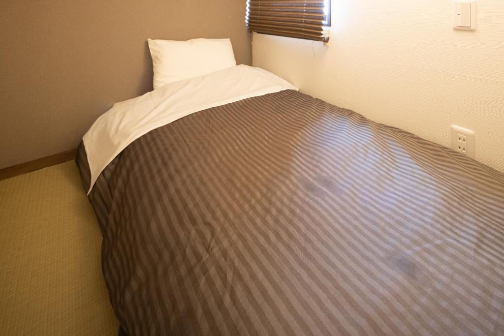 Postel nebo postele na pokoji v ubytování Hotel Tohko HakataGion