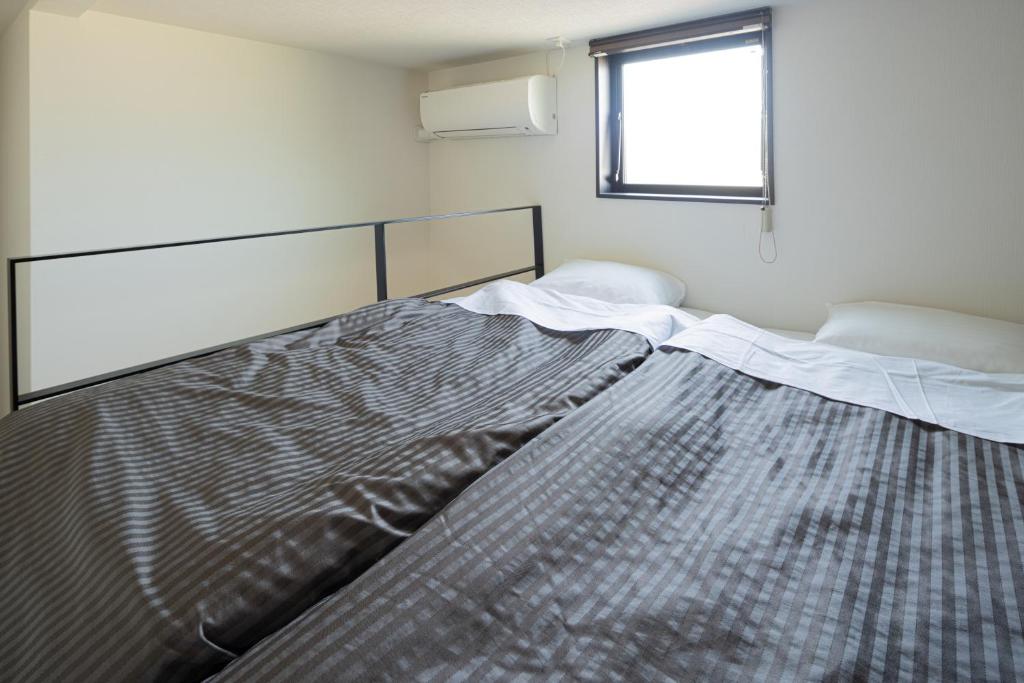 Postel nebo postele na pokoji v ubytování Hotel Tohko HakataGion