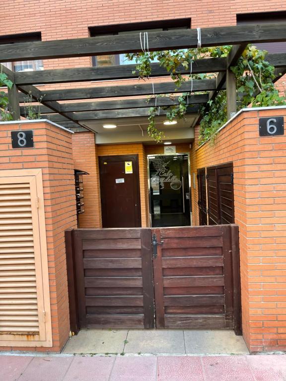 a wooden gate in front of a brick building at SeaHomes Vacations, FENALS BEACH&CHIC, pk, top apartment full equipped in Lloret de Mar