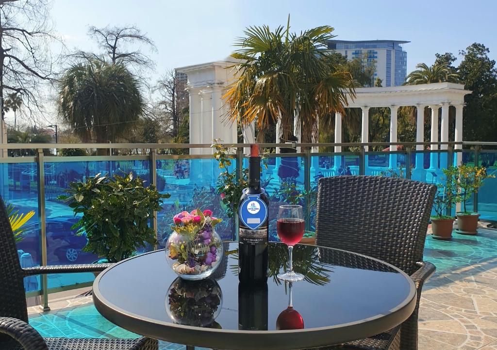 a table with a bottle of wine and a glass at Hotel Park in Batumi