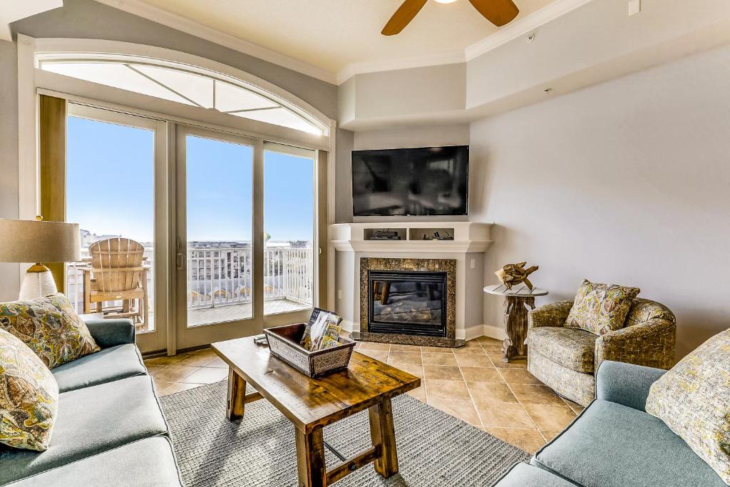 a living room with a fireplace and a tv at South Beach in Ocean City