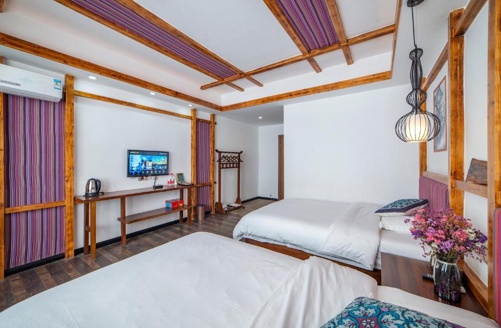 Letto o letti in una camera di Zhangjiajie Highlights Guesthouse