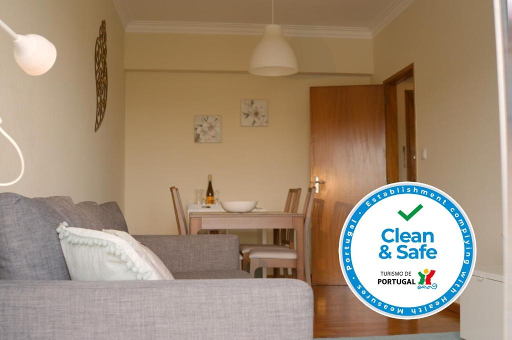 a living room with a sign that says clean and safe at B Apartamentos in Viana do Castelo