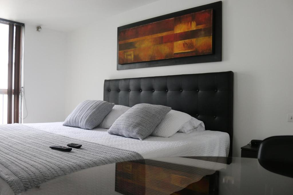 a bed with a glass table in a bedroom at Hotel Santa Maria in Popayan