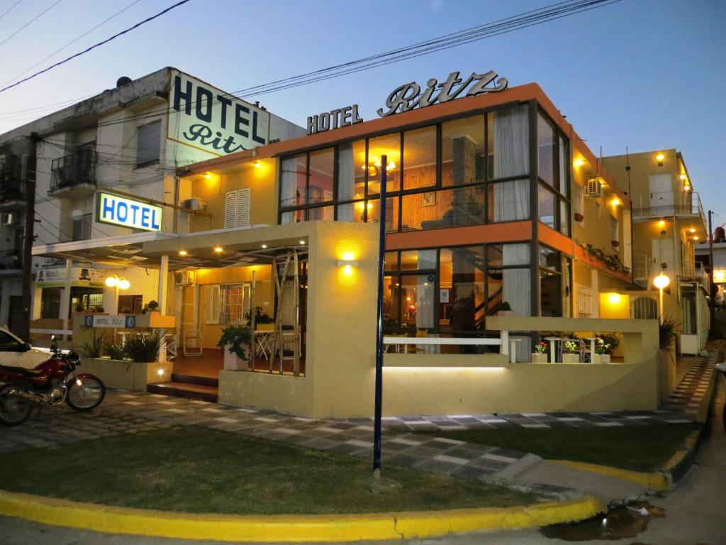 a hotel building with a motorcycle parked in front of it at Hotel Ritz in Villa Carlos Paz