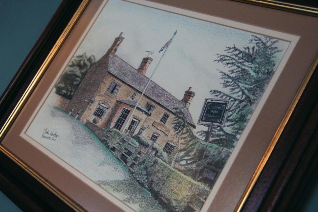 a painting of a building with a flag on it at The Dovecote Inn in Laxton