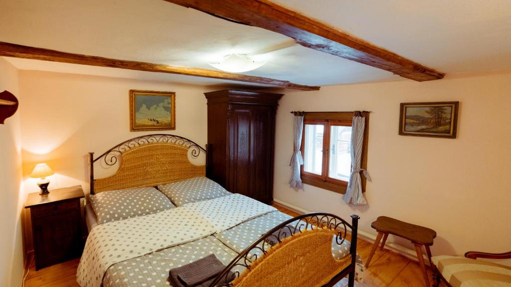 a bedroom with a large bed with a wooden headboard at Pension Rokytka in Kryštofovo Údolí